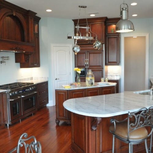 Custom kitchen with dark cabinets and marble countertops built by Archill Builders in Wilmington NC