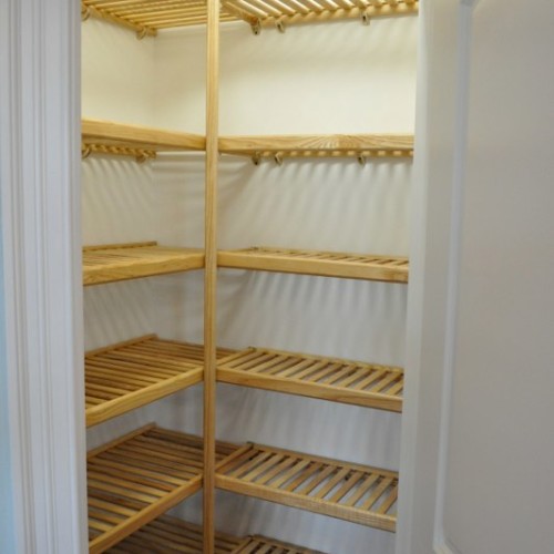 Linen closet with custom racks built by Archill Builders in WIlmington NC